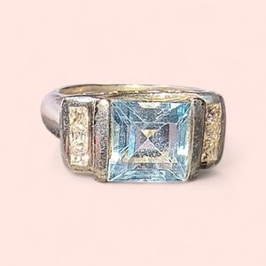 Blue Topaz, CZ  And Sterling Silver Ring In A Half Bezel Setting
